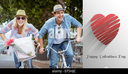 Immagine composita di hip coppia giovane di andare per un giro in bici Foto Stock