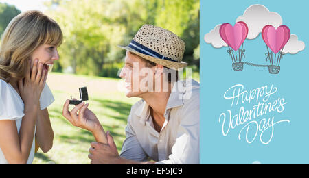 Immagine composita dell'uomo sorprendente la sua fidanzata con una proposta nel parco Foto Stock