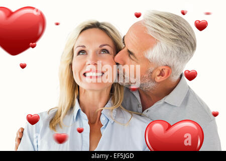 Immagine composita di affettuosa uomo baciando la moglie sulla guancia Foto Stock