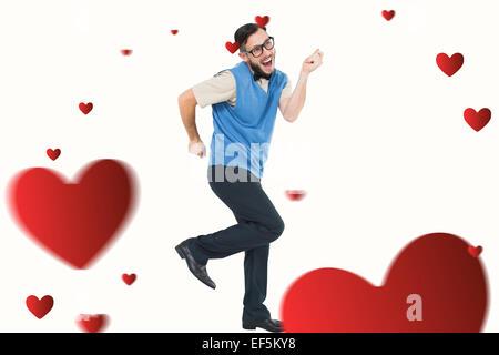 Immagine composita di geeky hipster dancing e sorridente Foto Stock