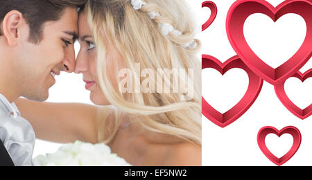 Immagine composita di felice giovane coppia sposata alla ricerca di ogni altro nel volto Foto Stock