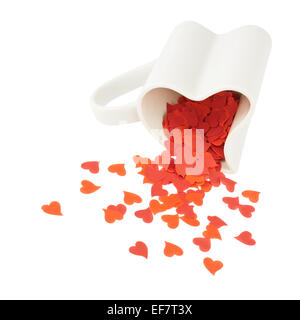 Cuore coriandoli cadere fuori della tazza Foto Stock