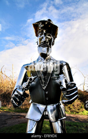 La vita di metallo di dimensioni scultura Cowboy con pistole disegnati sul ciglio della strada in East Anglia, REGNO UNITO Foto Stock