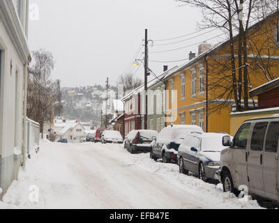 In inverno, Vålerenga Oslo Norvegia, piccola vecchia pannellate in legno case neve nelle strade e marciapiedi, sfidando il parcheggio in strada Foto Stock