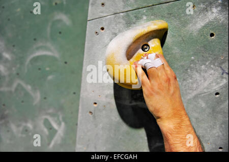 Dettaglio con scalatore ferito alla mano su artificiale di arrampicata Foto Stock