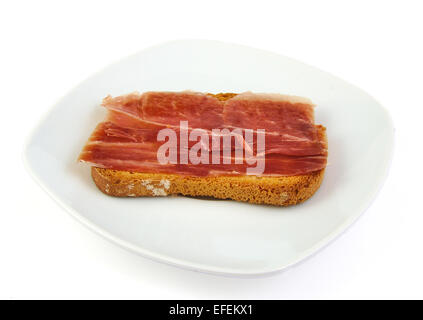 Il prosciutto Serrano sul pane tostato. Jabugo. Le tapas spagnole Foto Stock