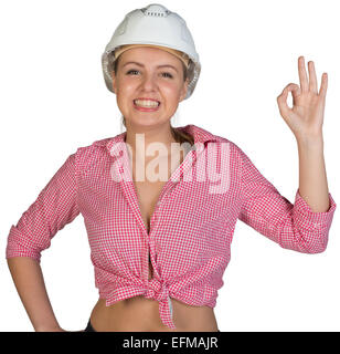 Donna in hard hat facendo bene gesto Foto Stock