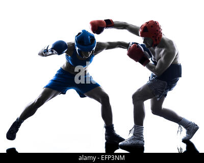 Una donna boxer boxing un uomo kickboxing in silhouette isolati su sfondo bianco Foto Stock