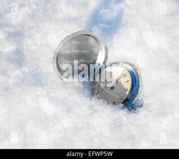 Orologio antico su uno sfondo di neve Foto Stock