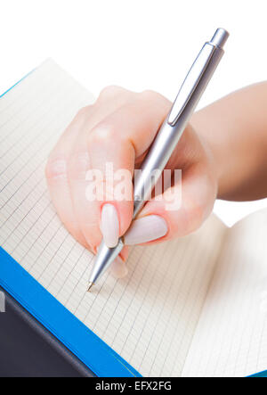 Donna di mano con una penna la scrittura in un notebook Foto Stock