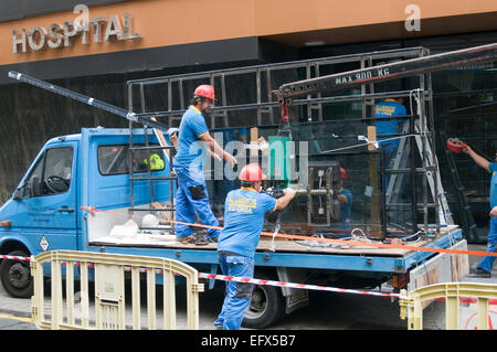Lastra di vetro negozio finestra riquadro windows i vetri di una grande installazione installazione di lavoro di sollevamento con fracassato rotto installato rep Foto Stock