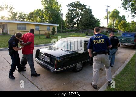 Noi Marescialli agenti di servizio e il Tulsa poliziotti arrestare un sospetto membro della gang durante il funzionamento del fascio triplo II a due settimane di repressione contro le gang violente Maggio 2, 2011 in Tulsa, Oklahoma. Foto Stock