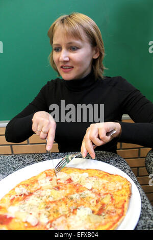 Immagine del ritratto del simpatico giovane donna in pizzeria Foto Stock