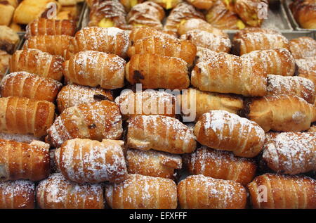 Il vassoio di cannoli con crema per la vendita in un negozio di pasticceria Foto Stock