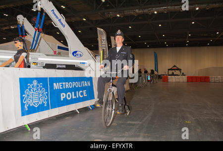 Excel, London, Regno Unito. Il 12 febbraio 2015. Il London Bike Show corre per 4 giorni, con una performance di ciclismo Theatre, StreetVelodrome e test in pista - con un poliziotto dimostrando un penny farthing. Credito: Malcolm Park editoriale/Alamy Live News Foto Stock