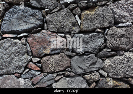 La texture di un muro fatto di pietra vulcanica Foto Stock