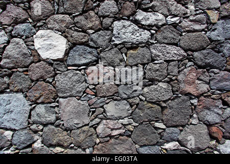 La texture di un muro fatto di pietra vulcanica Foto Stock