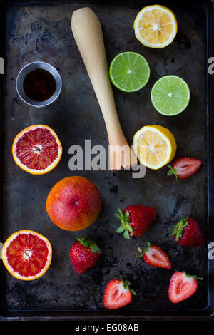 Arancio sanguigno, limone, calce e fragole su un vassoio da forno Foto Stock