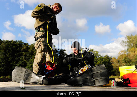 STANFORD AREA FORMAZIONE, Inghilterra - Senior Airman Nathan Simonson, 56th Rescue Squadron pararescueman, attribuisce una tagline per SrA Eli Reynolds, 56th RQS pararescuman, in preparazione per entrare in acqua per un recupero di subsurface esercizio. Lo slogan è usato per comunicare tra le persone tramite la linea estrarre segnali. Airman 1. Classe Losanna Morgan Foto Stock