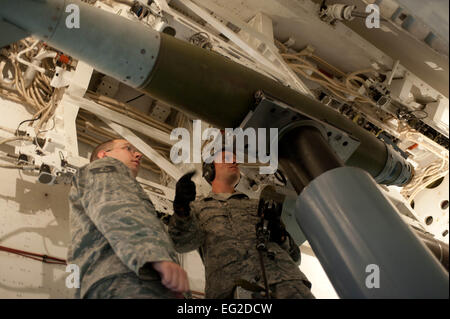 Il personale Sgts. Adam Borton sinistra e Ryan Woolie, 28 Manutenzione aeromobili squadrone carico di armamenti membri di equipaggio, fissare un inerte guidato unità bomba in una simulazione di B-1 bombardiere simulatore durante la formazione a Ellsworth Air Force Base, S.D., Agosto 13, 2013. In aggiunta alla formazione iniziale, tutte le armi caricatori sono valutati su base mensile per assicurare che essi mantengono la qualificazione e la competenza per la manipolazione e il trasporto di munizioni. Airman 1. Classe Zachary Hada Foto Stock