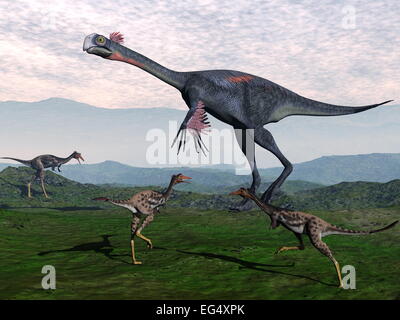 Gigantoraptor circondato da piccole mononykus dinosauri in montagna - 3D render Foto Stock