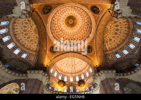 Nuova Moschea di Yeni Camii Cupola interna ottomana Istanbul Turchia / ISTANBUL, Turchia — il soffitto ornato di Yeni Camii (nuova Moschea) a Istanbul mostra la gerarchia piramidale di cupole e semi-cupole caratteristica dell'architettura imperiale ottomana del XVII secolo, coronata da una cupola centrale di 57 piedi (17,5 metri) di diametro. Il programma decorativo include piastrelle di Iznik con motivi floreali distintivi in blu cobalto, turchese e rosso corallo. La costruzione durò dal 1597 al 1663, inizialmente commissionata dal valide Sultan Safiye Sultan e completata sotto il valide Sultan Hatice Turhan Sultan, con il fu Foto Stock