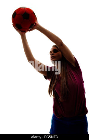 Silhouette di una ragazza a giocare il gioco del calcio sul bianco Foto Stock