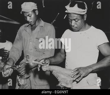 African American quartermaster soldati riparazione di battaglia scarponi indossati dalle truppe di combattimento. Essi erano stazionati nel Marianas Foto Stock