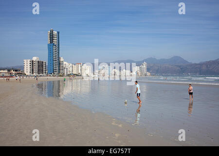 Due giovani ragazzi che giocano a calcio su una spiaggia Foto Stock