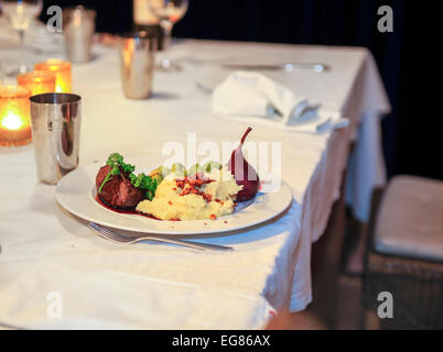 Piastra con patate, carne e verdure sul tavolo Foto Stock