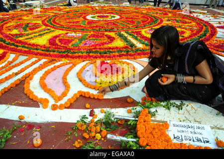 Dacca in Bangladesh. Il 21 febbraio, 2015. Giovani del Bangladesh decorano il Bangladesh Lingua centrale dei martiri monumento commemorativo con fiori in omaggio ai martiri del 1952 lingua Bengali movimento, presso l'università di Dhaka campus a Dhaka il 21 febbraio 2015. Essa segna 63 anni da quando la polizia ha sparato a migliaia di dimostranti presso una università in Bangladesh impegnativo che essere bengalese ha dichiarato lo stato di lingua. Credito: Mamunur Rashid/Alamy Live News Foto Stock