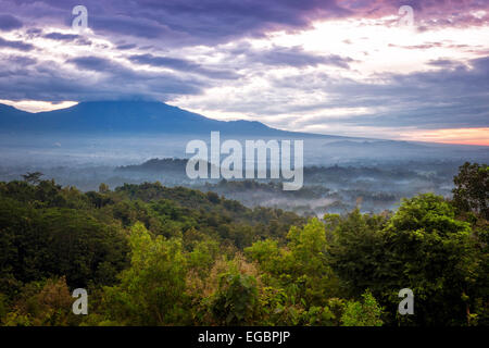 Tramonto su una valle con il Tempio Borobudur in distanza Foto Stock