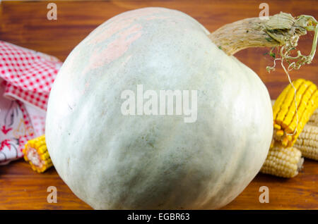 Enorme di zucca e di mais essiccato su un tavolo di legno Foto Stock