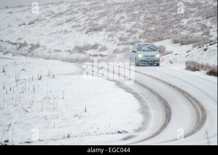 Mynydd Epynt, Powys, Wales, Regno Unito. Il 22 febbraio, 2015. Meteo REGNO UNITO: automobilisti sulla B4520 'Brecon' strada tra Builth Wells e Brecon sono colti di sorpresa da una bufera di neve in alto la brughiera di Mynydd Epynt gamma di colline. Credito: Graham M. Lawrence/Alamy Live News. Foto Stock