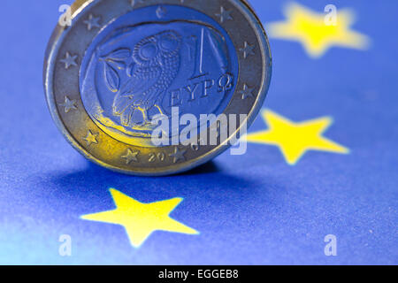 Il greco un Euro moneta sulla UE-bandiera Foto Stock