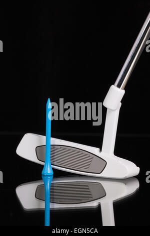 Golf putter e diverse attrezzature da golf sul vetro nero scrivania Foto Stock