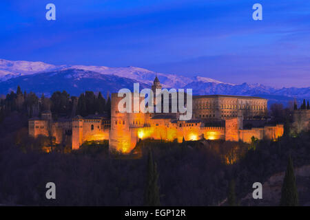 Alhambra, Sito Patrimonio Mondiale dell'UNESCO, della Sierra Nevada e la Alhambra al crepuscolo, Granada, Andalusia, Spagna Foto Stock