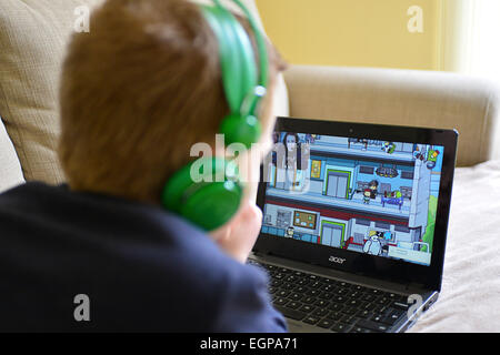 Giovane ragazzo giocando online giochi per computer sul computer portatile. Foto: George Sweeney / Alamy Foto Stock