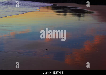 Orange alba nuvole riflettono sulla spiaggia bagnata St Ives Cornwall Inghilterra Europa Foto Stock