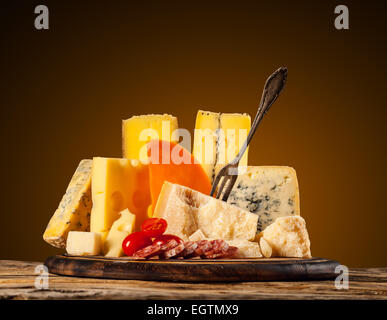 Vari tipi di formaggio servita su un tavolo di legno Foto Stock