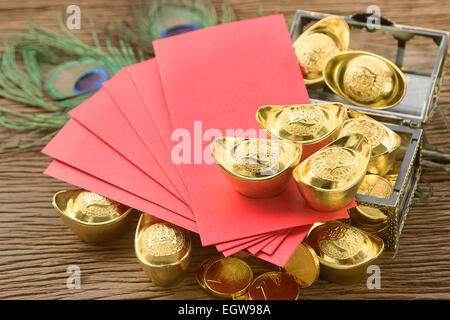 Anno Nuovo Cinese festival decorazioni, ang pow o pacchetto di rosso e oro lingotti. Foto Stock