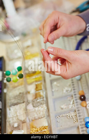 Juweler lavorando nel laboratorio di juwelry store su una collana Foto Stock