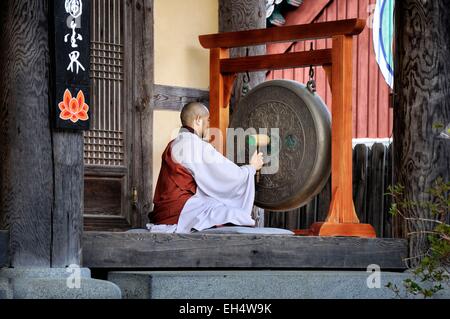 Corea del sud, sud Gyeongsang provincia (Gyeongsangnam-do), Gayasan, monaco squilla il gong nel tempio buddista di Tempio di Haeinsa elencati come patrimonio mondiale dall' UNESCO Foto Stock