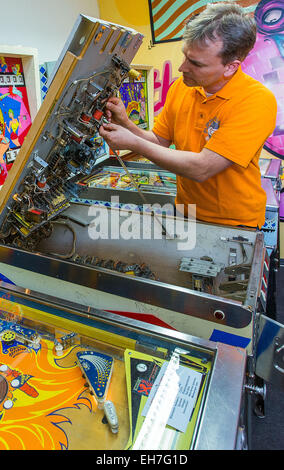 Arne Hennes, capo del museo di flipper in Schwerin, Germania, riparazioni "Jack in the Box' flipper, 27 febbraio 2015. Foto: Jens Buettner/dpa Foto Stock