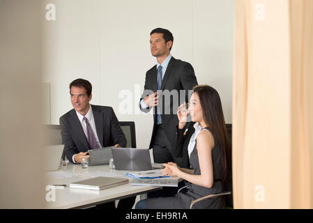 I dirigenti riuniti nella sala conferenze, visto attraverso la porta Foto Stock