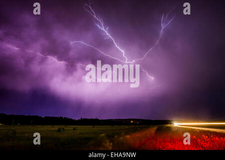 Il fulmine striature lungo il lato inferiore di una tempesta nuvola sulla prateria in Springbank, a ovest di Calgary, Alberta, Canada. Foto Stock