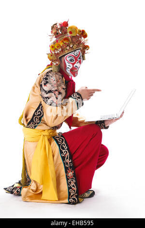 Pechino il carattere di opera Sun Wukong tenendo un computer notebook Foto Stock