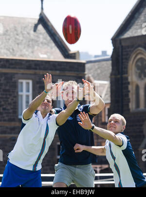 (150311) -- MELBOURNE, Marzo 11, 2015 (Xinhua) -- piloti di Formula Uno il finlandese Valtteri Bottas (R) e il brasiliano Felipe Massa(L) dal team Williams tenti Australian Rules Football con AFL player Joel Selwood durante la loro esperienza di AFL sessione alla scuola di grammatica de Melbourne a Melbourne, Australia sul Mar 11, 2015. (Xinhua/Bai Xue) Foto Stock