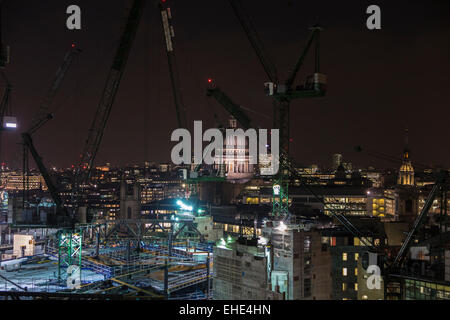 City of London EC4 skyline notturno - vista panoramica di gru su Bloomberg edificio sito in costruzione e la Cattedrale di St Paul e illuminata dietro Foto Stock