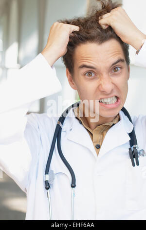 Close-up verticale di un arrabbiato giovane medico Foto Stock